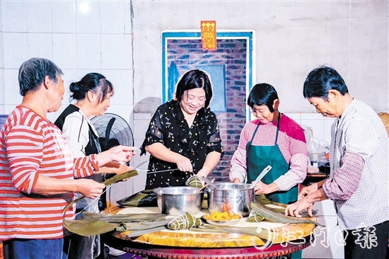 非遺傳承人呂艷卿正在傳授柴火粽的制作技藝。