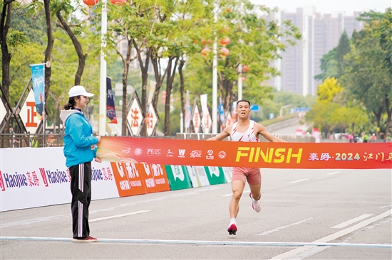 江門馬拉松半程終點(diǎn)設(shè)在江海區(qū)，江海賽道涉及多個(gè)地標(biāo)性區(qū)域。圖為“半馬”第一名選手沖線。郭永樂